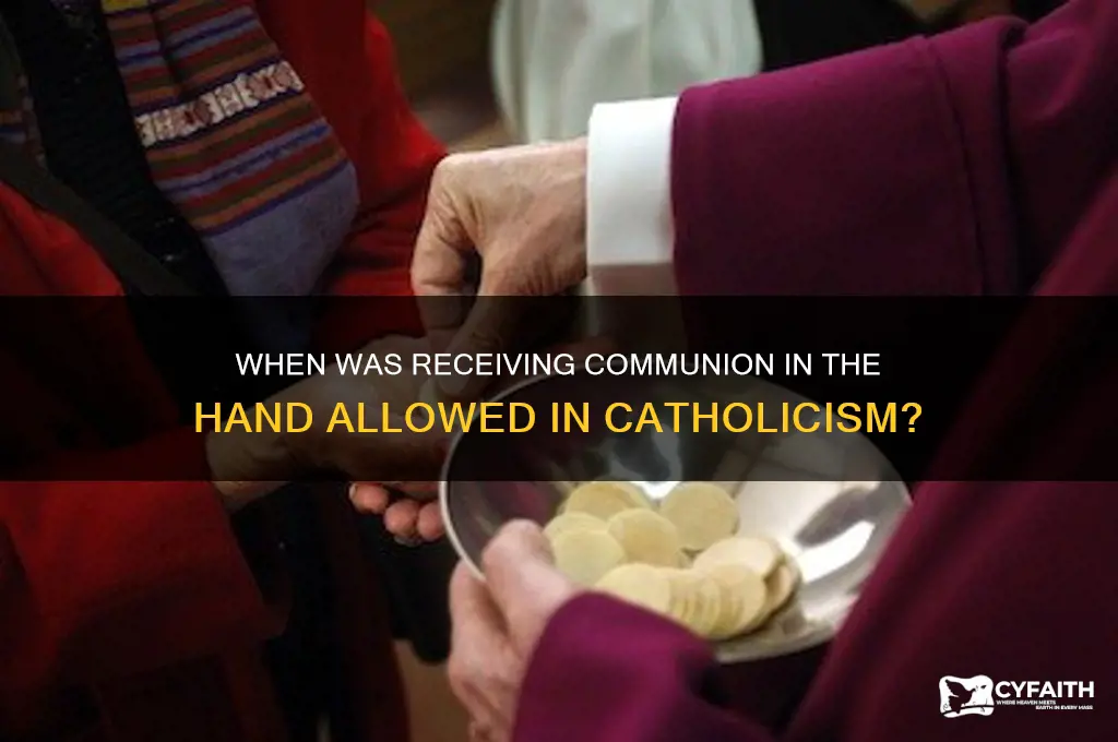 when host into the hand was permitted catholic