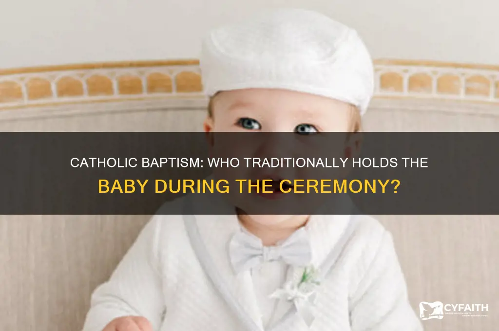 who holds baby during catholic baptism